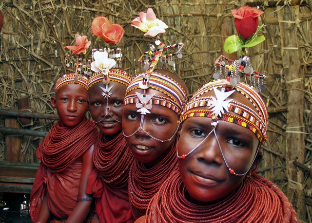 Notice the colourful flowers on the headgears of these African bridesmaid